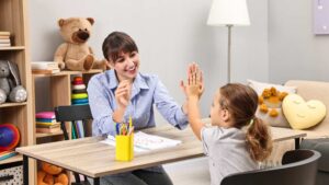 A child working with an ABA therapist in a cozy setting with toys around, showing everyday support related to level 1 autism
