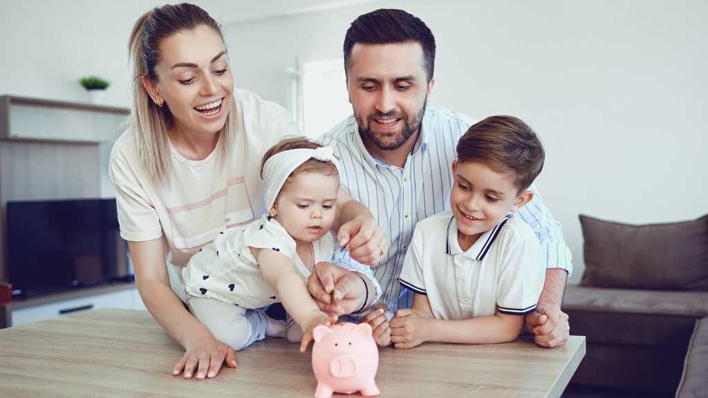 Autism and Finances: A Practical Guide to Financial Planning for Families in Virginia Family budgeting together with children placing money into a piggy bank, symbolizing financial planning for autism support in Virginia.