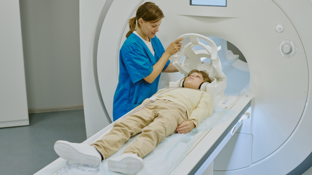 Child receiving MRI scan to assess medical conditions associated with autism