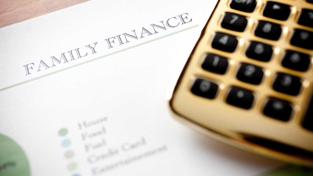 Autism and Finances: A Practical Guide to Financial Planning for Families in Virginia Family finance planning worksheet and calculator on a desk, representing practical tips for managing autism and finances.