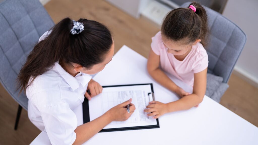 What Is the Y-BOCS Scale? Understanding Autism and OCD Professional completing an assessment with a child