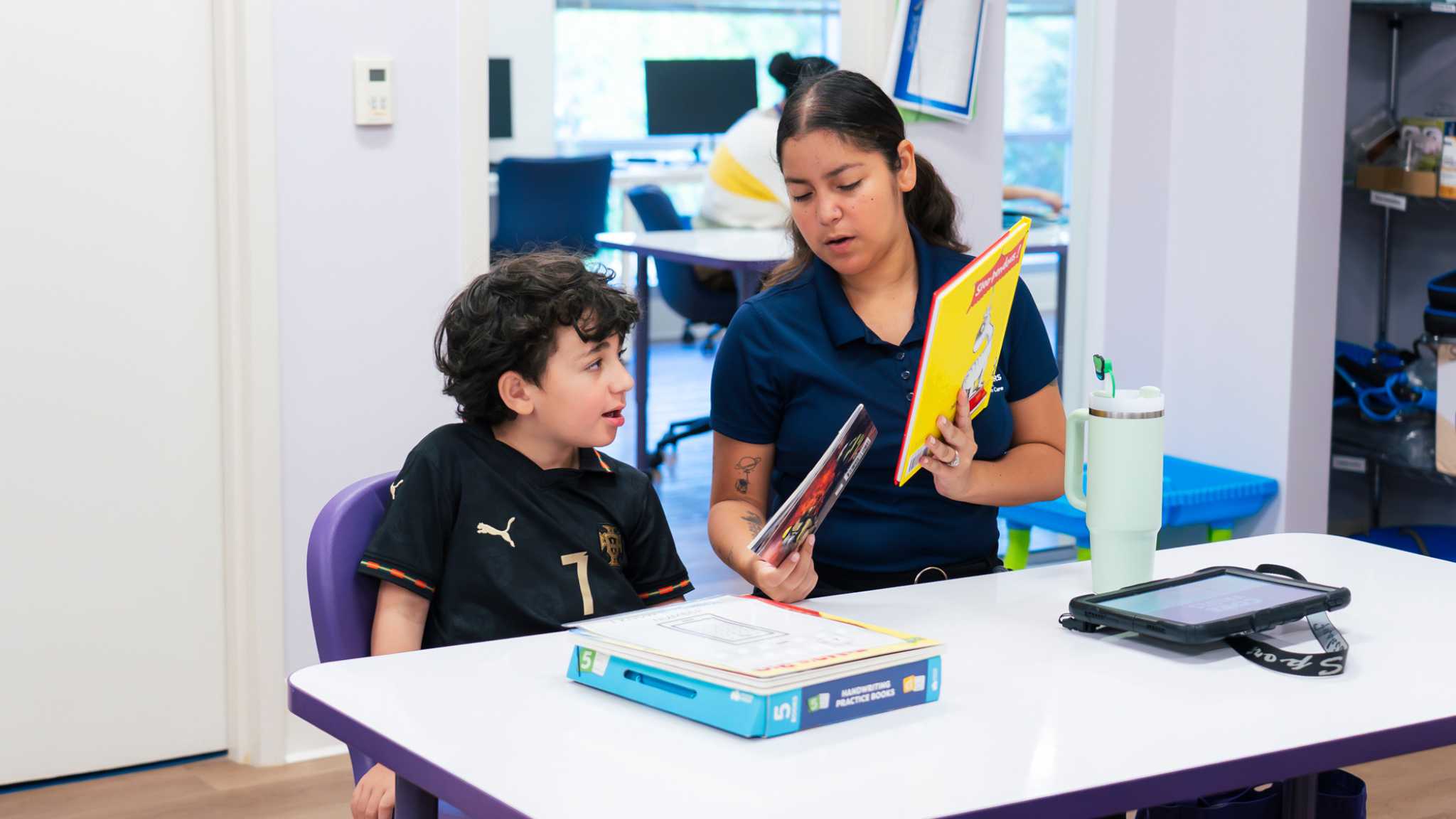 Understanding Your Child's Autism Evaluation Report Therapist reviewing materials with a child after an autism assessment report