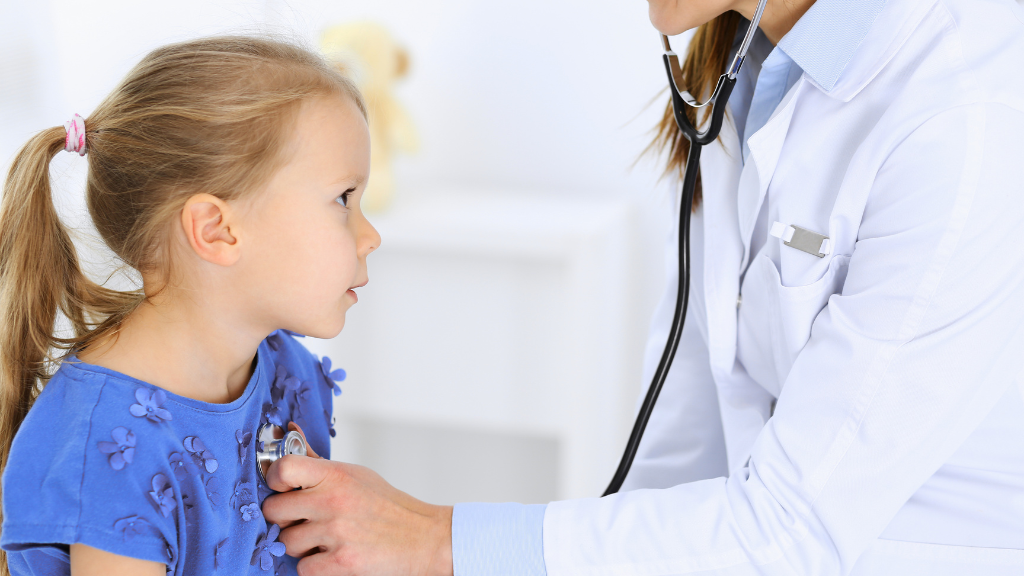 Doctor examining child during checkup related to medical conditions associated with autism