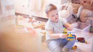 Young child with autism playing independently with toys during everyday routines