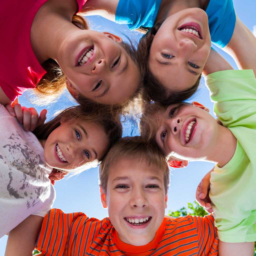 Neurodivergent vs Neurodiverse: Beyond the Buzzword Group of happy children forming a circle outdoors, symbolizing individuality, connection, and the essence of neurodivergent meaning within neurodiversity