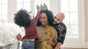 Parents playing with their child during a family activity illustrating the positives in an autism parenting journey