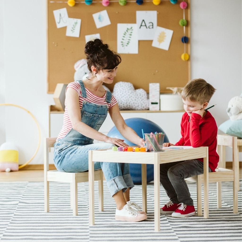 Teacher supporting a child during a learning activity