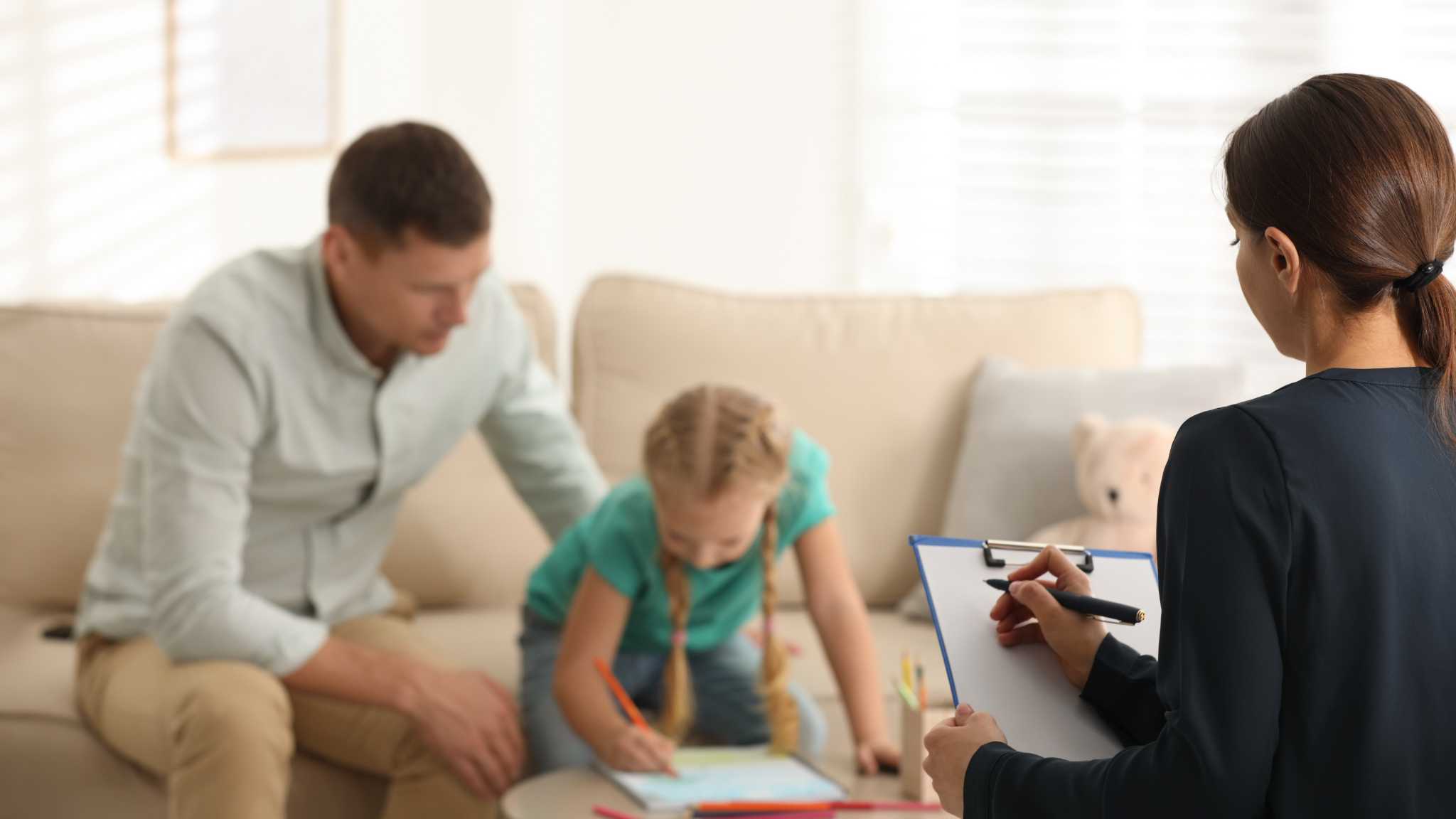 Understanding Your Child's Autism Evaluation Report Clinician observing child and parent while reviewing autism evaluation results